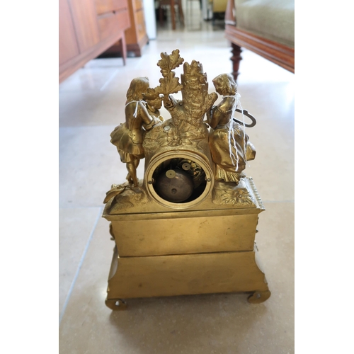 619 - A French gilt bronze mantle clock, modelled with a courting couple above, 45cm high.