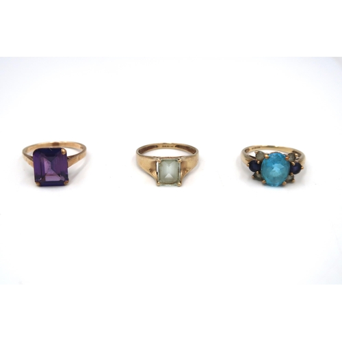 62 - Three 9ct gold dress ring. To include an amethyst single stone, size S, an aquamarine single stone, ... 