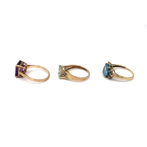 62 - Three 9ct gold dress ring. To include an amethyst single stone, size S, an aquamarine single stone, ... 