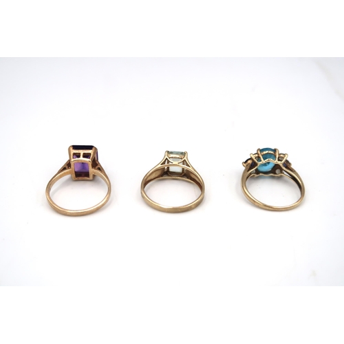 62 - Three 9ct gold dress ring. To include an amethyst single stone, size S, an aquamarine single stone, ... 