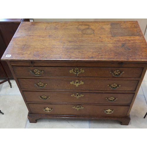 625 - A Georgian oak chest with a brushing slide over three drawers with a nice patina.