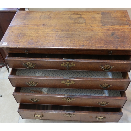 625 - A Georgian oak chest with a brushing slide over three drawers with a nice patina.