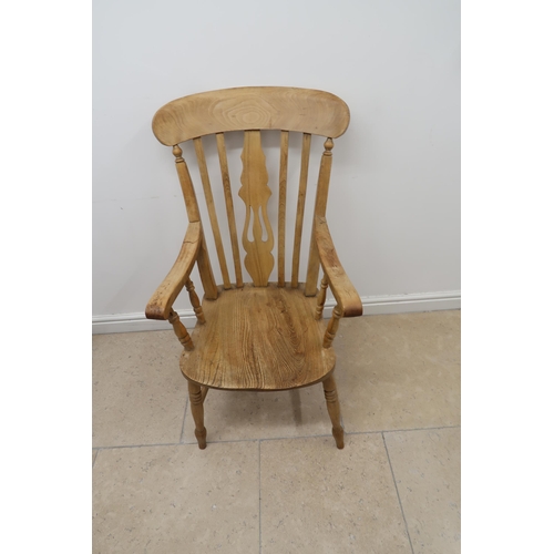 635 - A Grandfather Lyre back  Windsor armchair raised on turned supports joined by H stretcher.
105cm hig... 