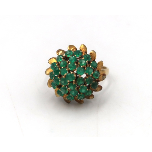 64 - A green stone bombe style cocktail ring. Stamped 18K. Size R. Weight 4.89 grams