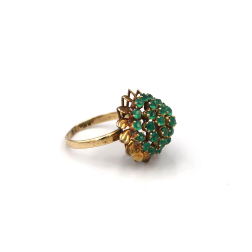 64 - A green stone bombe style cocktail ring. Stamped 18K. Size R. Weight 4.89 grams