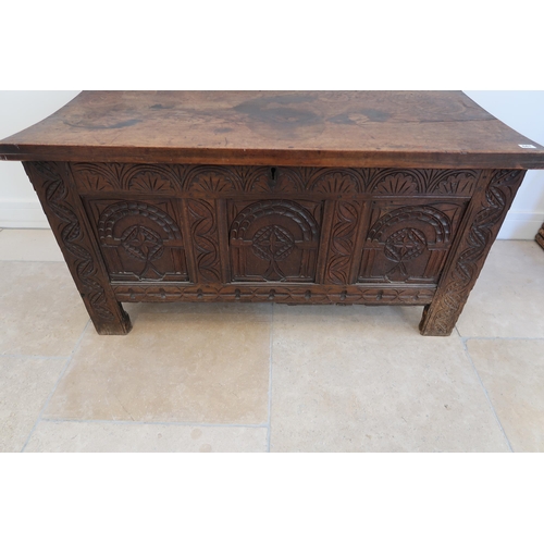 641 - An 18th century oak coffer with a three panel carved front with a nice patina - Width 117cm x Height... 