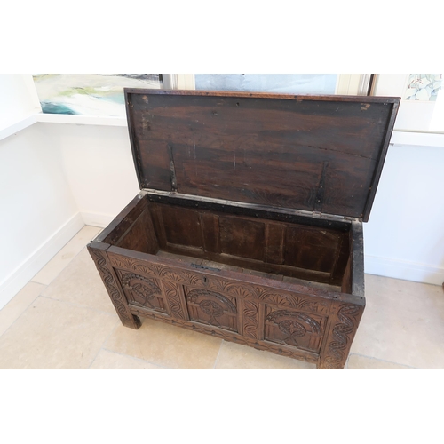 641 - An 18th century oak coffer with a three panel carved front with a nice patina - Width 117cm x Height... 