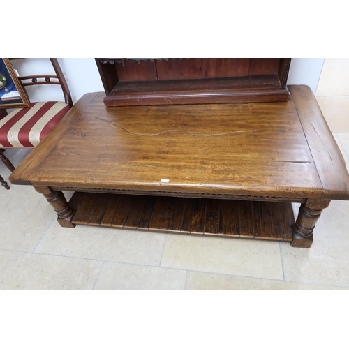 720 - A Large refectory style coffee table raised on turned supports. (In Good Condition). 150cm wide x 90... 