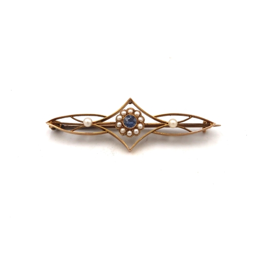 84 - A 15ct marked yellow gold bar brooch, with central flowerhead setting, with blue stone surrounded by... 