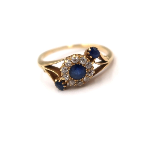 99 - A sapphire and old cut diamond crossover cluster ring. Size L. Tests gold 18ct. Weight 2.50 grams