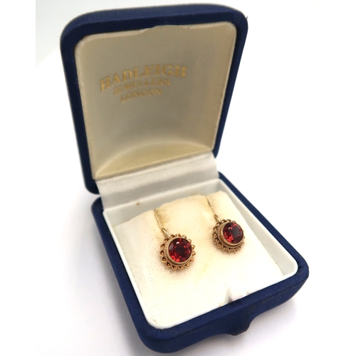  A pair of 9ct hallmarked yellow gold and garnet earrings - approx weight 2.2 grams