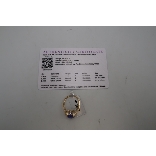 117 - A 9ct gold oval top faceted tanzanite and zircon dress ring, size M. Weight 2.75 grams