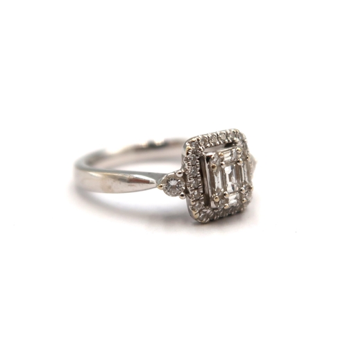 12 - An 18ct white gold baguette and brilliant cut diamond cluster ring - stated total diamond weight 0.4... 