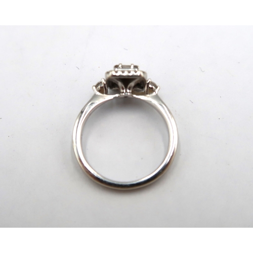 12 - An 18ct white gold baguette and brilliant cut diamond cluster ring - stated total diamond weight 0.4... 