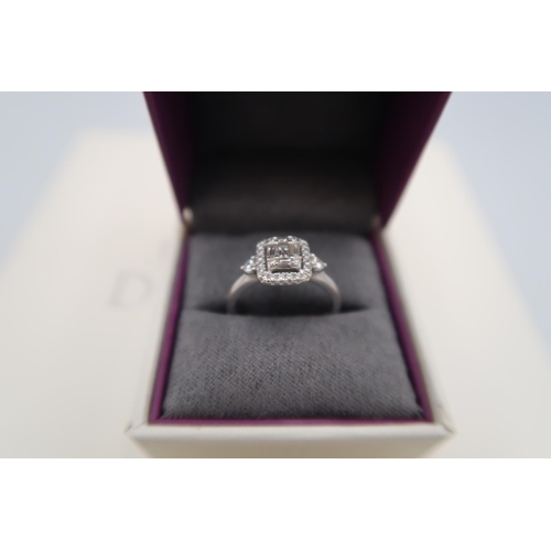 12 - An 18ct white gold baguette and brilliant cut diamond cluster ring - stated total diamond weight 0.4... 