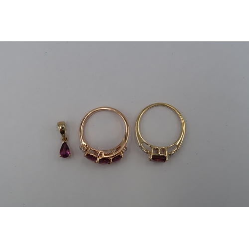 122 - Three pieces of 9ct garnet jewellery. To include a pear shape garnet pendant. A three stone garnet a... 