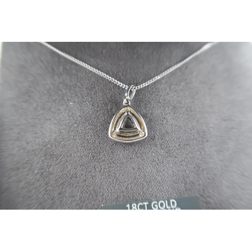 13 - An 18ct white gold triangular Tanzanite and diamond pendant on an 18ct gold chain - approx weight 3.... 