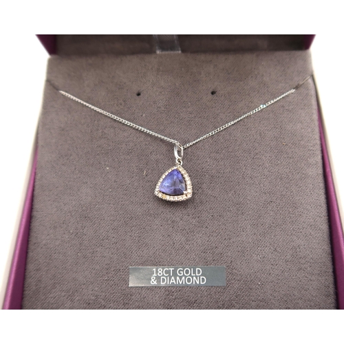 13 - An 18ct white gold triangular Tanzanite and diamond pendant on an 18ct gold chain - approx weight 3.... 