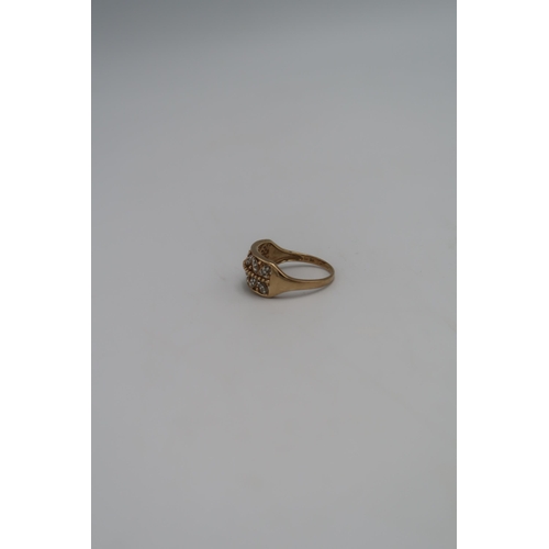 131 - A marked .375 yellow gold dress ring pierced shoulder with small diamonds. Size T. 3.6grams.