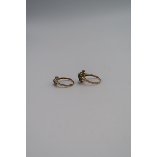 132 - Two marked .375 Yellow gold dress rings, One Amethyst and diamond and one green gem stone flower hea... 