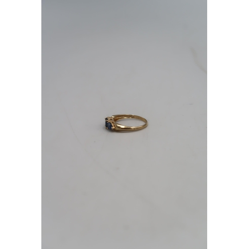 134 - A 14ct gold and sapphire three stone ring, size S, hallmarked, 2.9g.