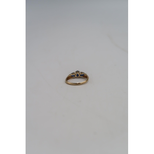 134 - A 14ct gold and sapphire three stone ring, size S, hallmarked, 2.9g.