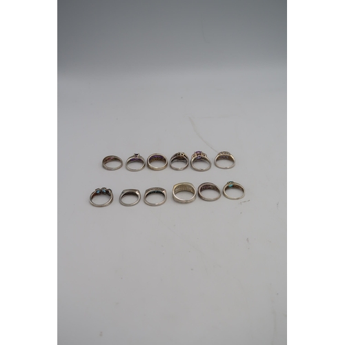 135 - A group of approximately twelve silver rings all hallmarked, of various designs and sizes, total wei... 