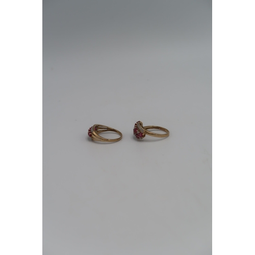 136 - A marked .375 Yellow gold dress ring with five oval cut Rubies to shoulder flanked by small round cu... 