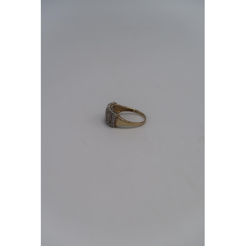 137 - A marked .375 Yellow gold dress ring with baguette cut diamonds to shoulder Size T. 3.4grams.