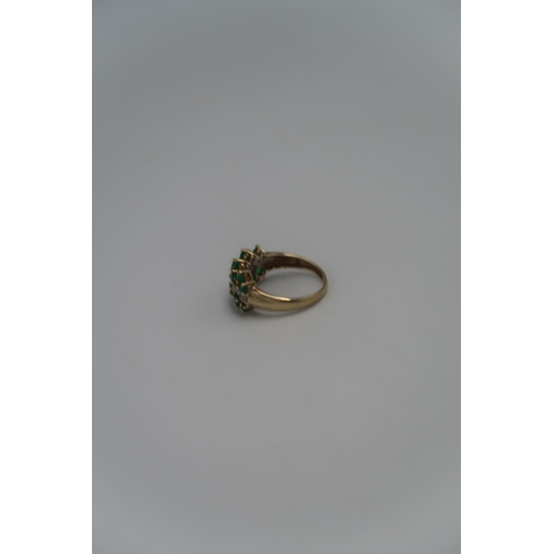 139 - A marked .375 Yellow gold dress ring with central line of small round cut diamonds, Size T. 3.8grams... 