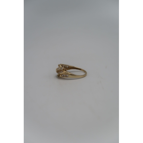 145 - A marked .375 Yellow gold dress ring set with twenty four clear round cut stones to shoulder Size T ... 