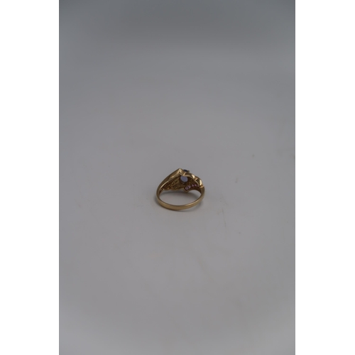 149 - A marked .375 Yellow gold dress rings with central Lilac coloured stone flanked by round cut citrine... 