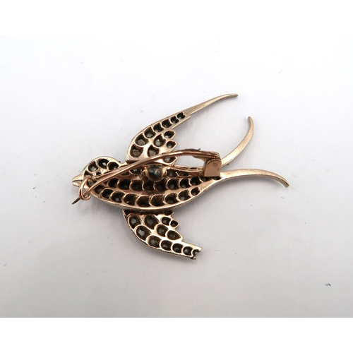 15 - A rose cut diamond swallow brooch. Tests silver and gold. Length 45mm - Bottom wing requires repair ... 