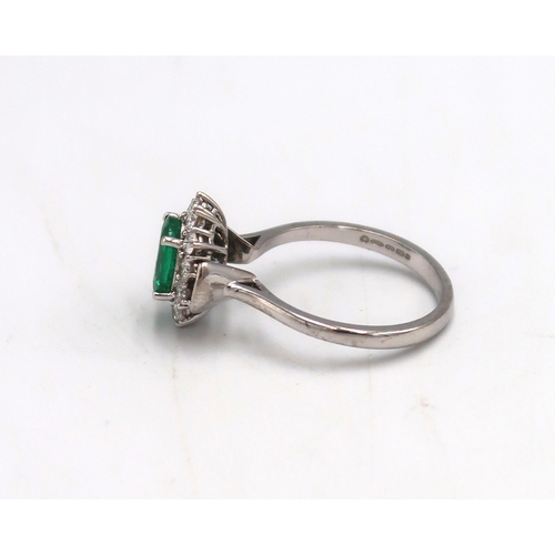 152 - A 18ct White gold Dress ring. approx. 1.5ct emerald surrounded by 12 brilliant cut diamonds Size P 4... 