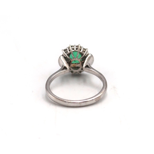 152 - A 18ct White gold Dress ring. approx. 1.5ct emerald surrounded by 12 brilliant cut diamonds Size P 4... 