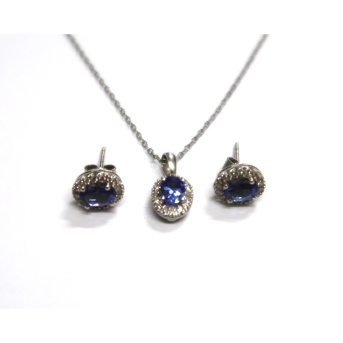 155 - A pair of Tanzanite earrings and pendant set in silver