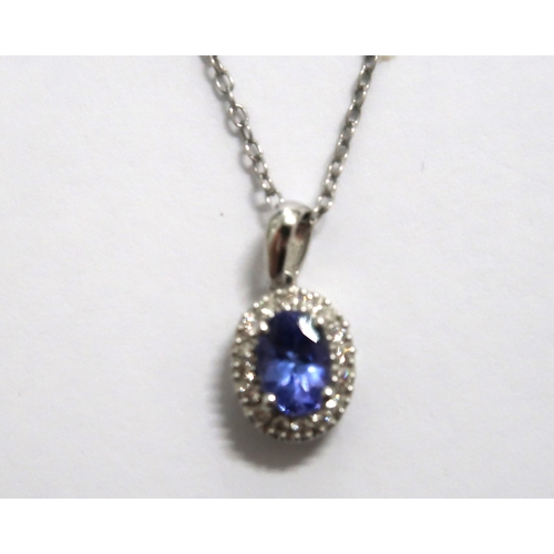 155 - A pair of Tanzanite earrings and pendant set in 14ct white gold