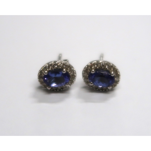 155 - A pair of Tanzanite earrings and pendant set in 14ct white gold