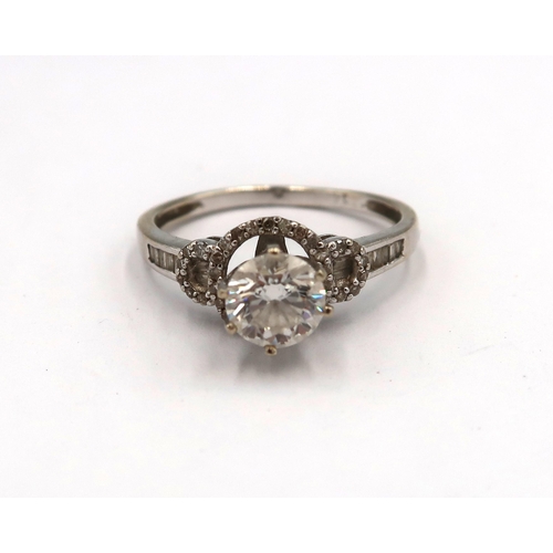 163 - A 14ct white gold diamond solitaire ring - The round brilliant cut diamond surrounded with round and... 