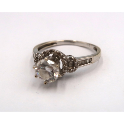 163 - A 14ct white gold diamond solitaire ring - The round brilliant cut diamond surrounded with round and... 