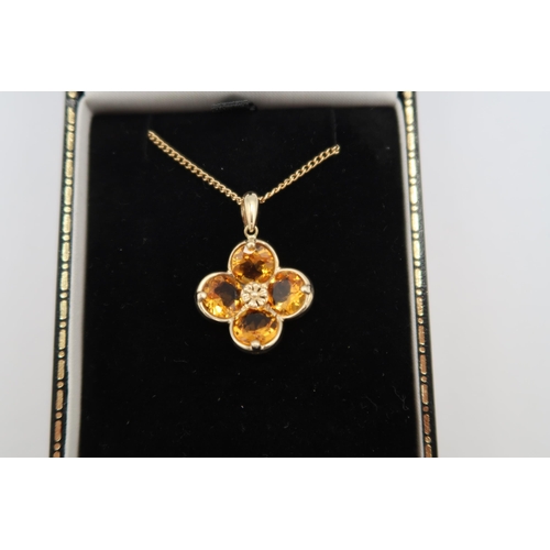 169 - A 9ct yellow gold citrine pendant, citrines are well cut and well matched, good colour, on a 9ct yel... 