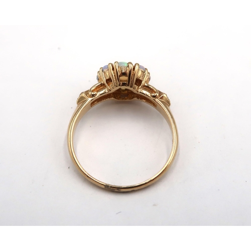 171 - A 9ct yellow gold opal and diamond ring, opals are a good colour and well matched with diamond shoul... 