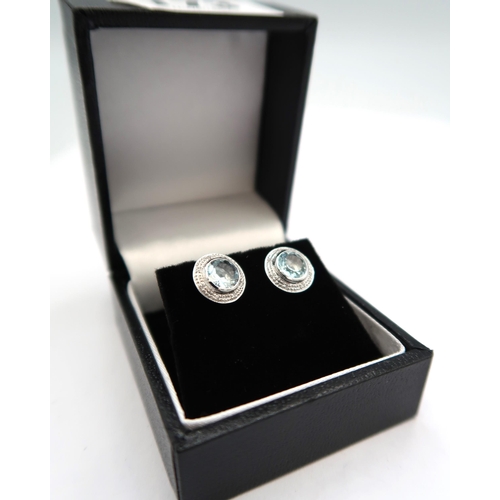 173 - An 18ct white gold aquamarine and diamond earrings, aquamarines are a good colour and well matched, ... 