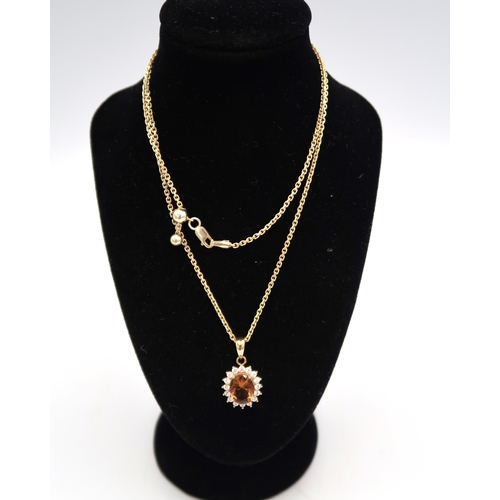 178 - A .925 silver gilt citrine and white zircon pendant with an adjustable chain, chain approx 48cms lon... 