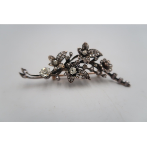 18 - An early 20th century diamond foliate brooch, set with old and rose cut diamonds. The larger old cut... 