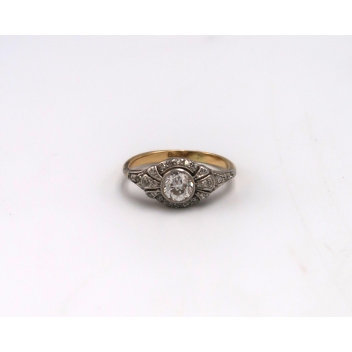 182 - An Art Deco 18ct gold and diamond dress ring, the central stone of approximately 1ct, surrounded by ... 