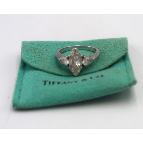 185 - A Tiffany diamond and platinum three stone ring, set with a central marquise cut diamond, 1.41ct, cl... 