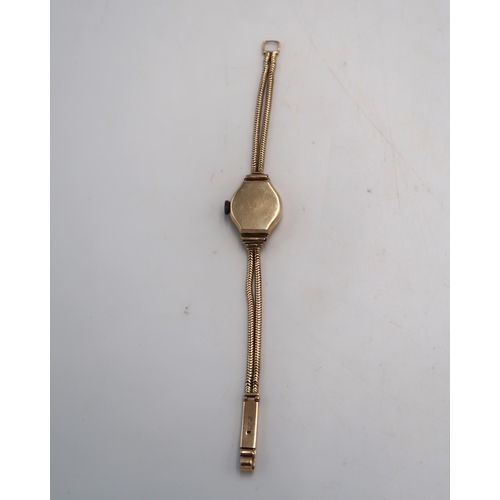 191 - A lady's 9ct gold cased Tissot cocktail watch with 9ct gold double snake link strap, total weight in... 