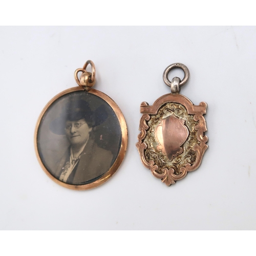 192 - A 9ct gold pendant frame of double sided circular form and a silver fob or medal with applied gold s... 