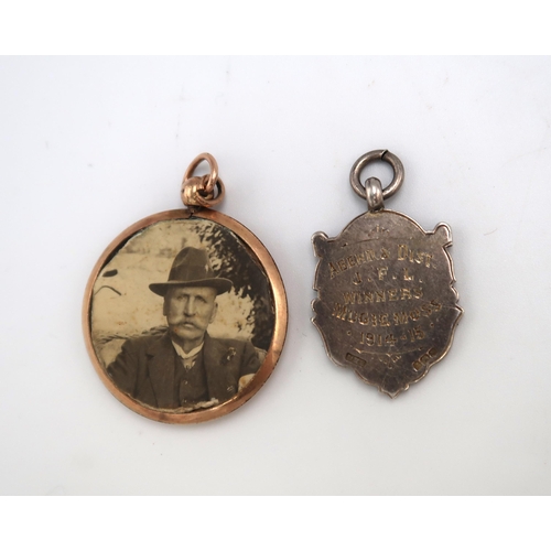 192 - A 9ct gold pendant frame of double sided circular form and a silver fob or medal with applied gold s... 